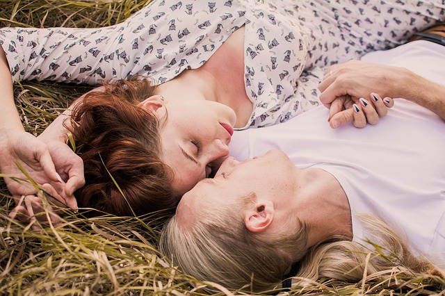 Muž a žena spolu ležia v suchej tráve.jpg